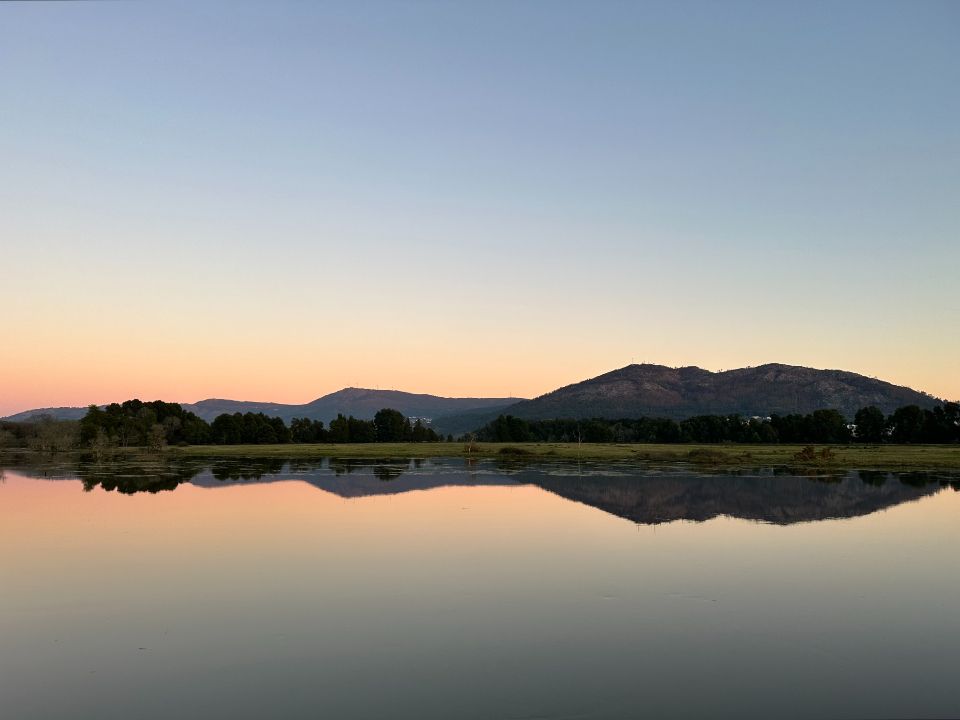 The lake, still, with hills behind